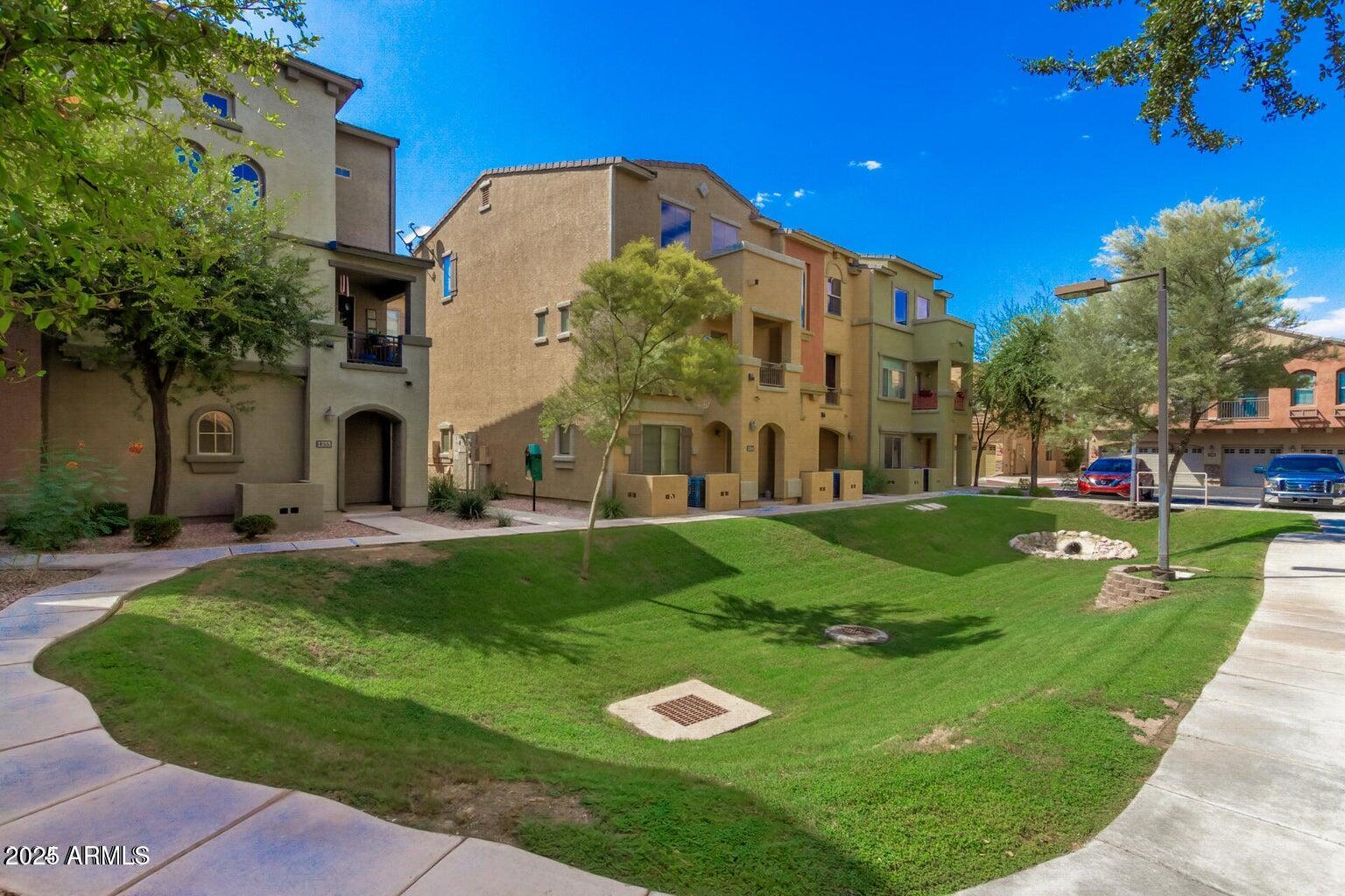 2402 East 5th Street, Unit 1402 Tempe, AZ 85288 - Photo 28 of 36 a front view of a house with a yard