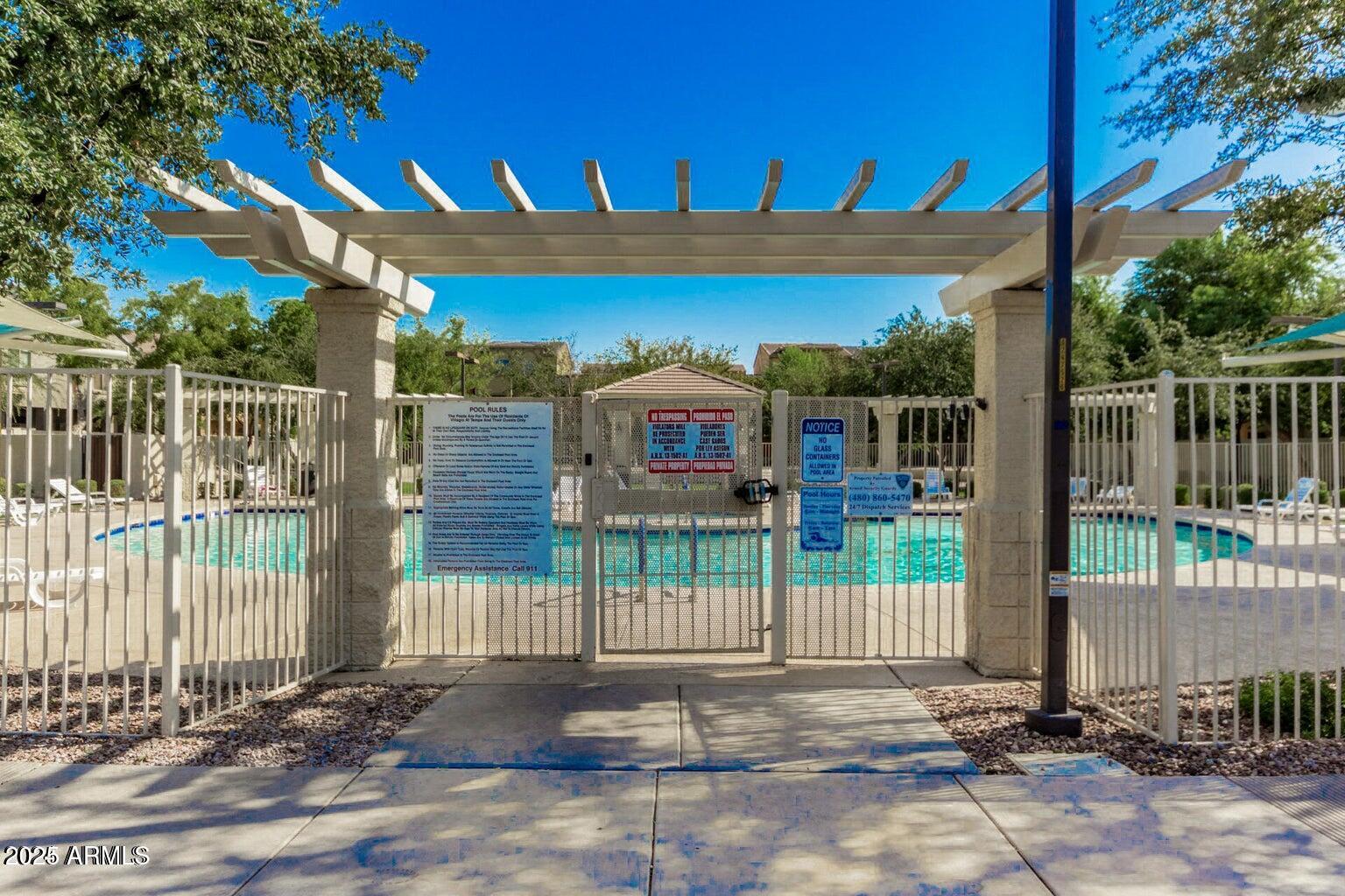 2402 East 5th Street, Unit 1402 Tempe, AZ 85288 - Photo 30 of 36 a view of a brick house with a small yard and large trees