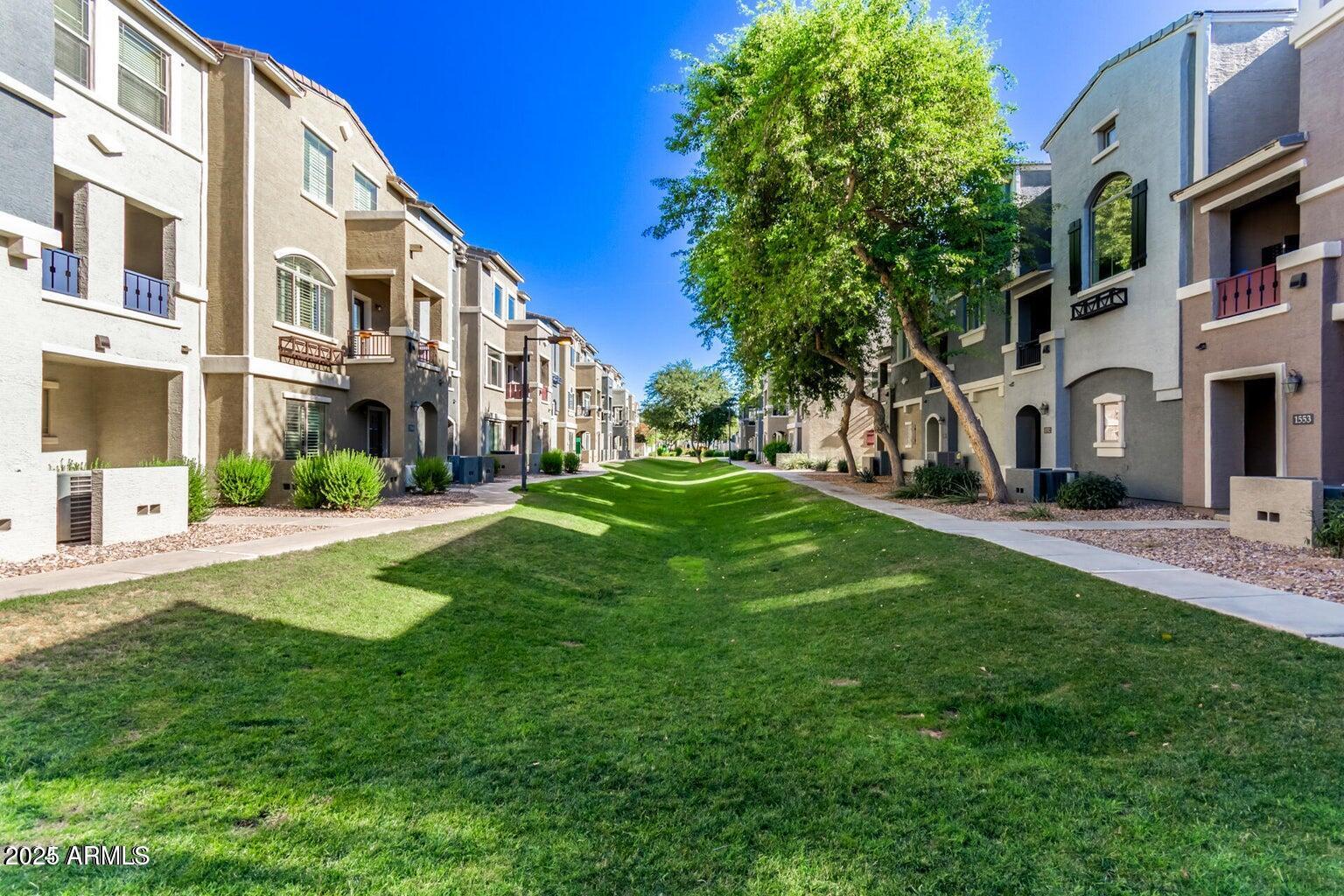2402 East 5th Street, Unit 1402 Tempe, AZ 85288 - Photo 33 of 36 a view of a building with a yard