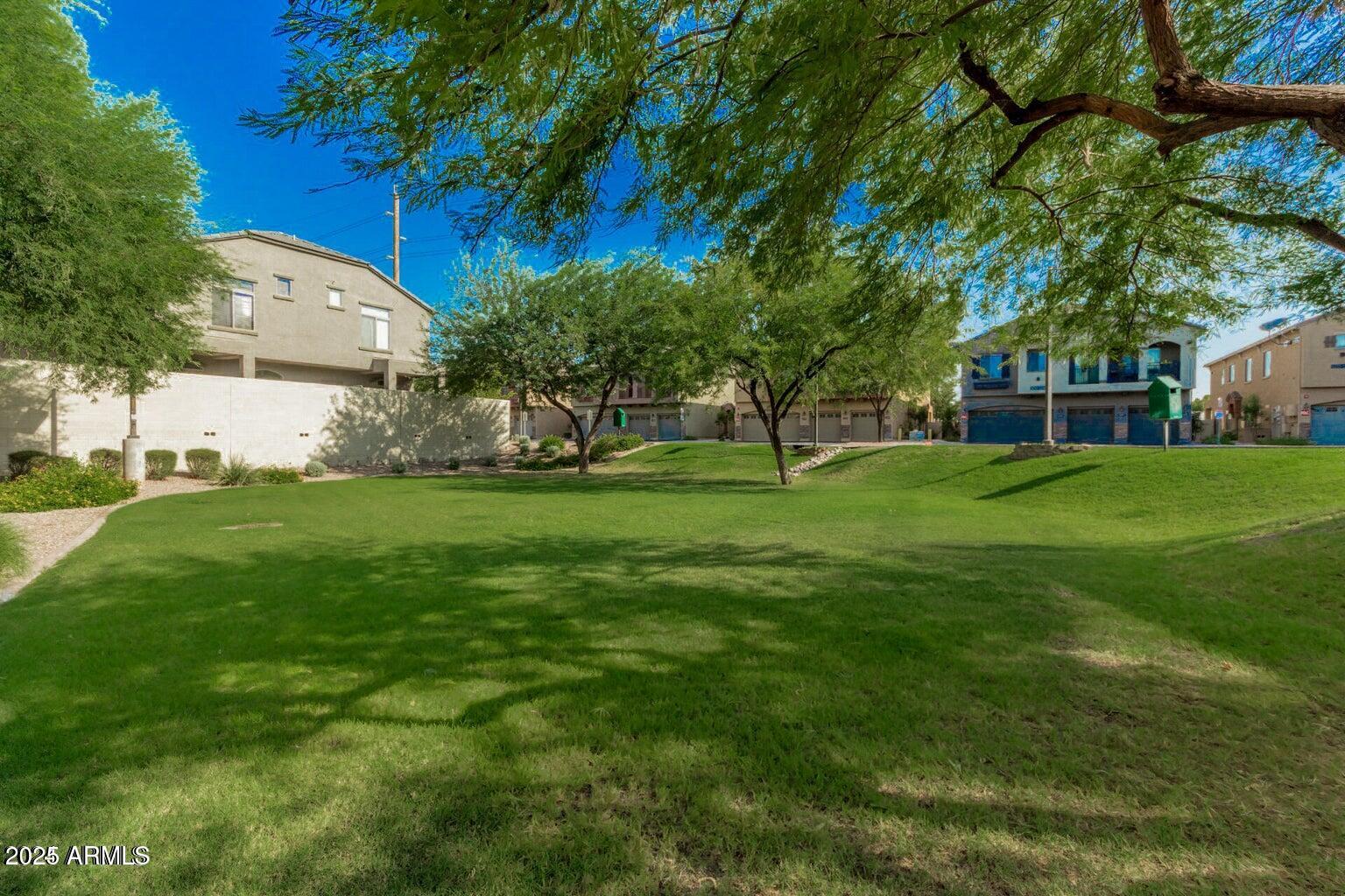 2402 East 5th Street, Unit 1402 Tempe, AZ 85288 - Photo 35 of 36 a view of a backyard with large trees