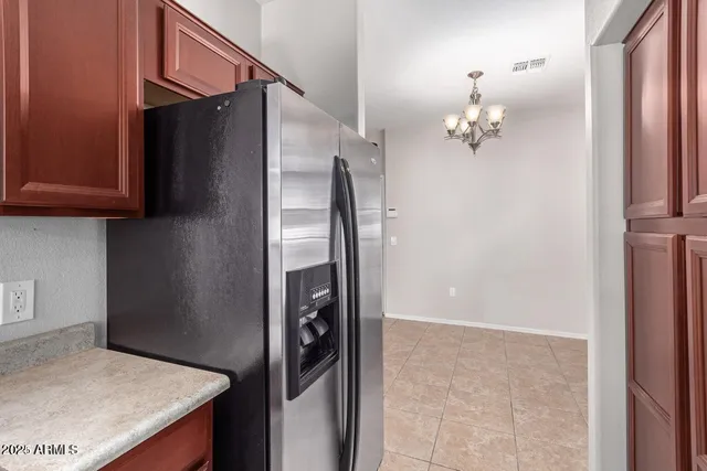 a view of kitchen cabinets and refrigerator