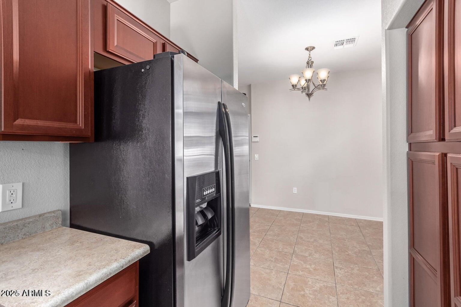 2402 East 5th Street, Unit 1402 Tempe, AZ 85288 - Photo 5 of 36 a view of kitchen cabinets and refrigerator