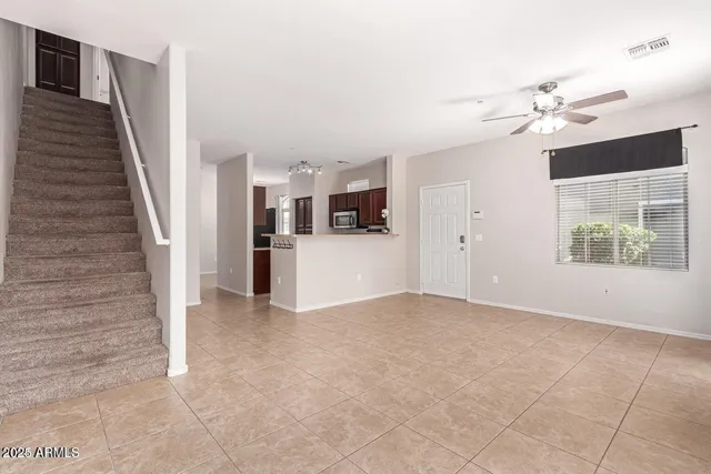 a view of a kitchen with wooden cabinet and a ceiling fan