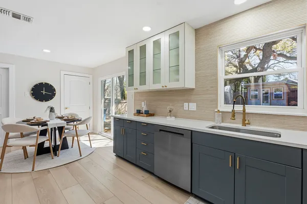a kitchen with stainless steel appliances granite countertop a refrigerator and a stove