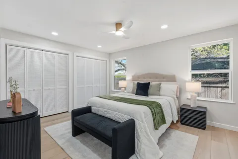 a bedroom with a large bed and a window