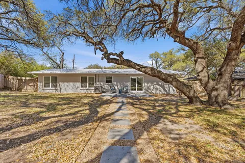 a view of a backyard with large trees