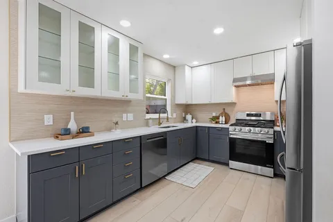a living room with furniture kitchen view and a table