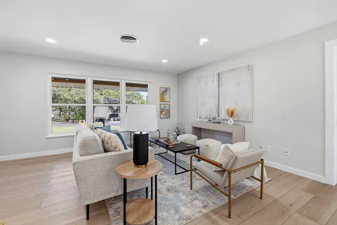 a living room with furniture and wooden floor