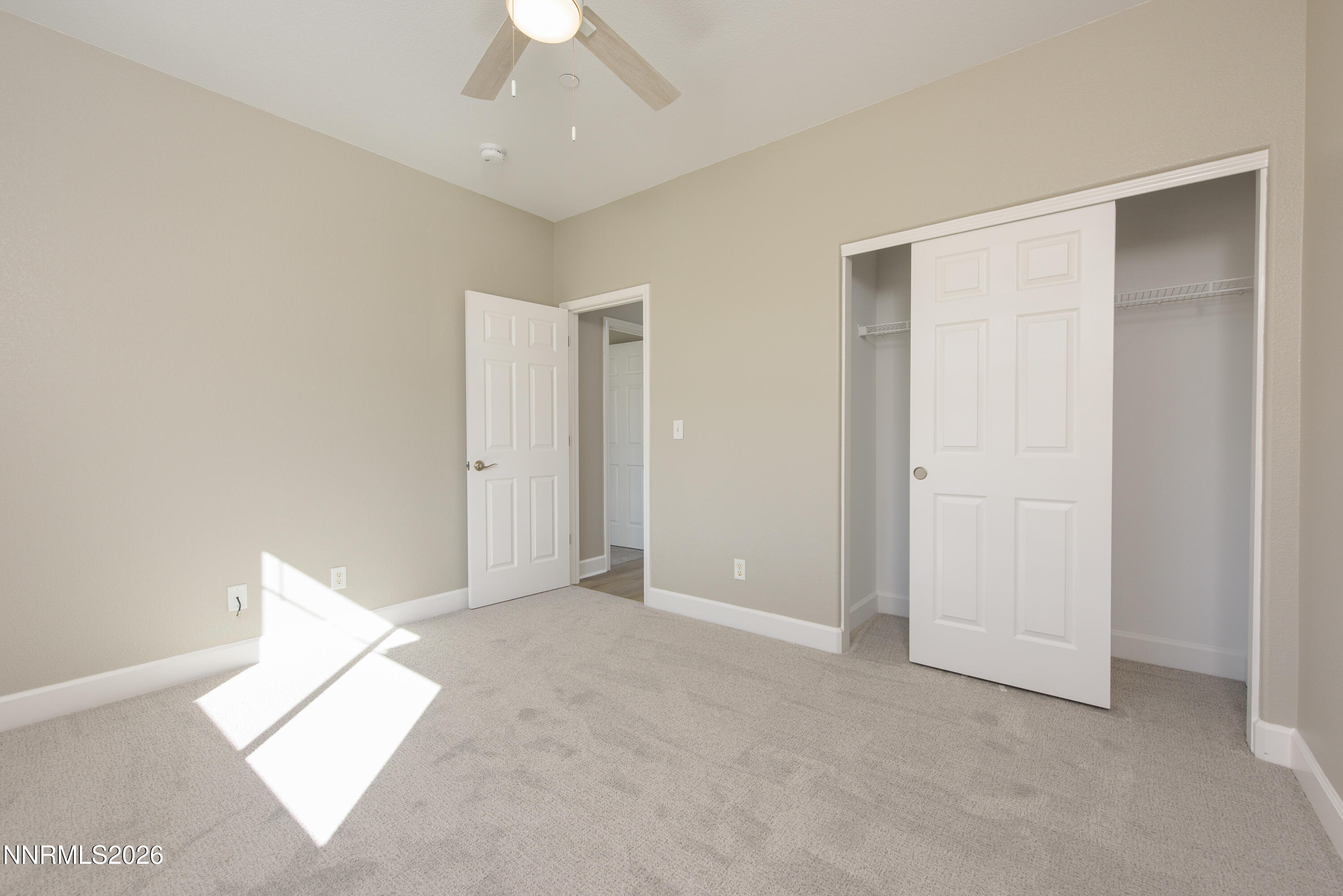 1221 Fonterra Way Carson City, NV 89701 - Photo 17 of 27 an empty room with a ceiling fan and a window