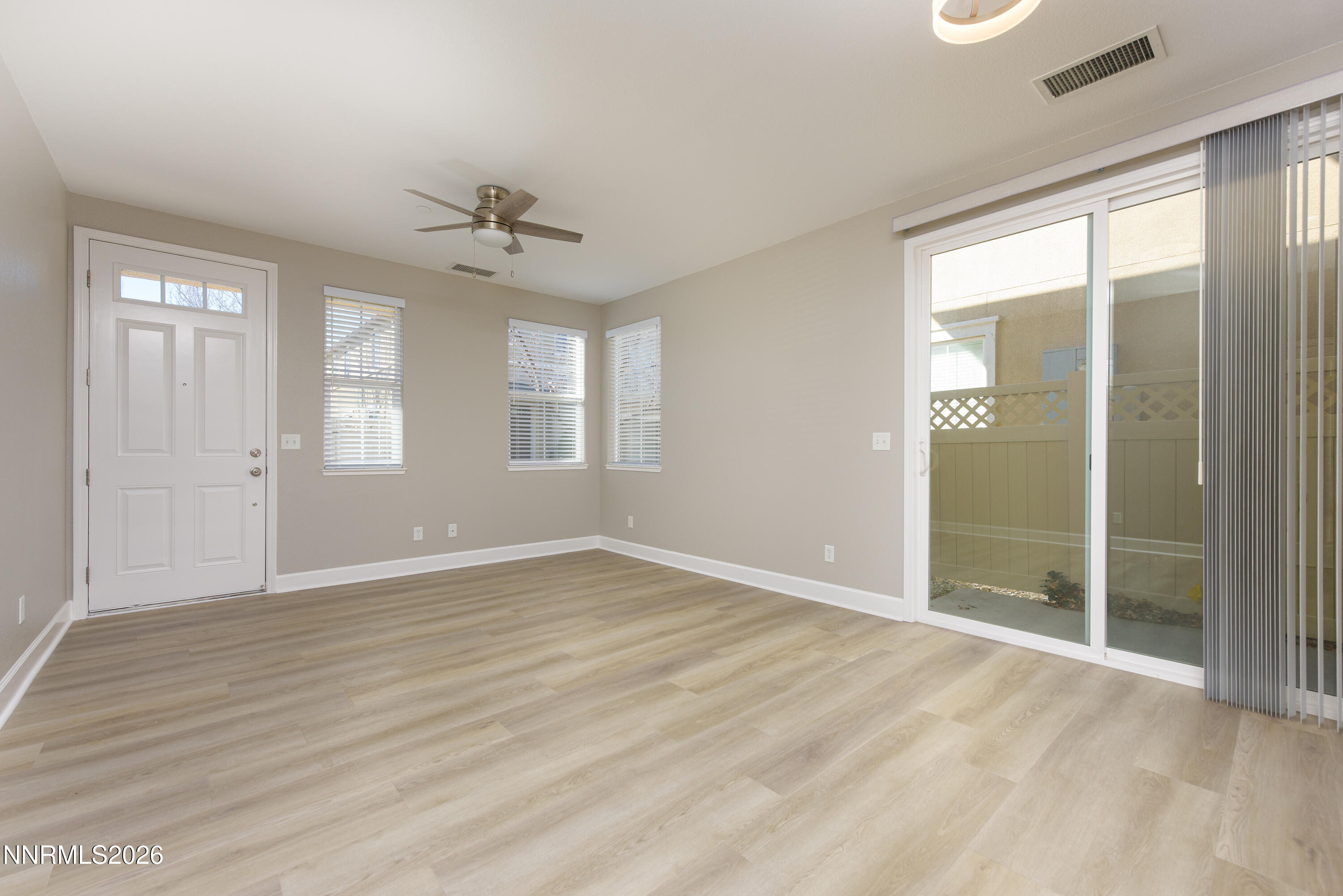 1221 Fonterra Way Carson City, NV 89701 - Photo 4 of 27 wooden floor in an empty room with a window