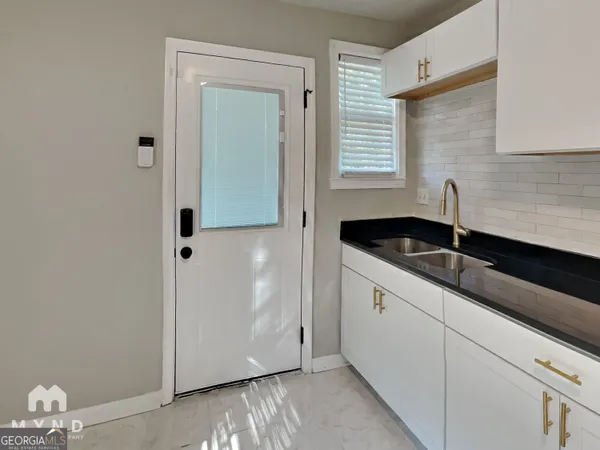 a kitchen with a sink and cabinets