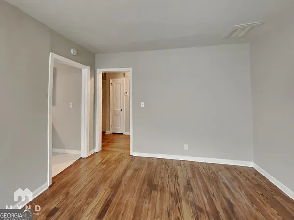 a view of a room with wooden floor