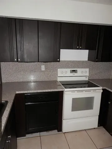 a kitchen with a stove and a microwave