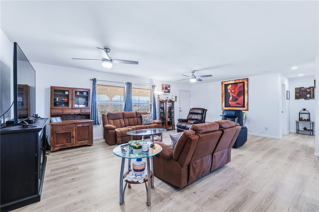 429 South Lochiel Road Golden Valley, AZ 86413 - Photo 12 of 61 Living area featuring light wood-style flooring and ceiling fan