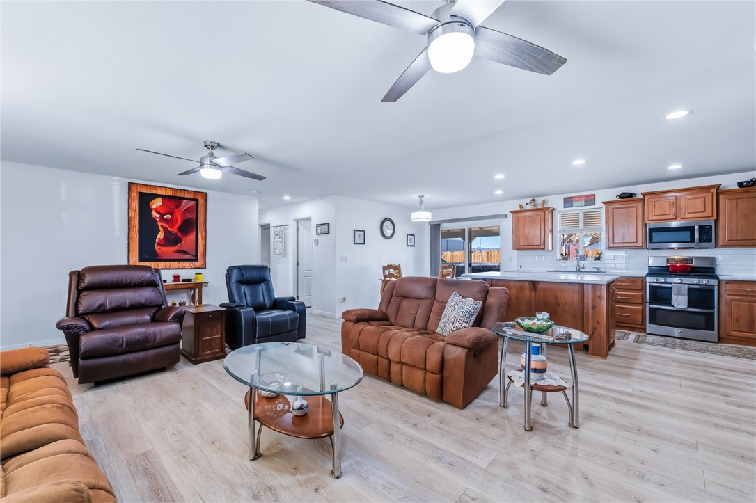 429 South Lochiel Road Golden Valley, AZ 86413 - Photo 13 of 61 Living room featuring recessed lighting, light wood-style floors, and a ceiling fan