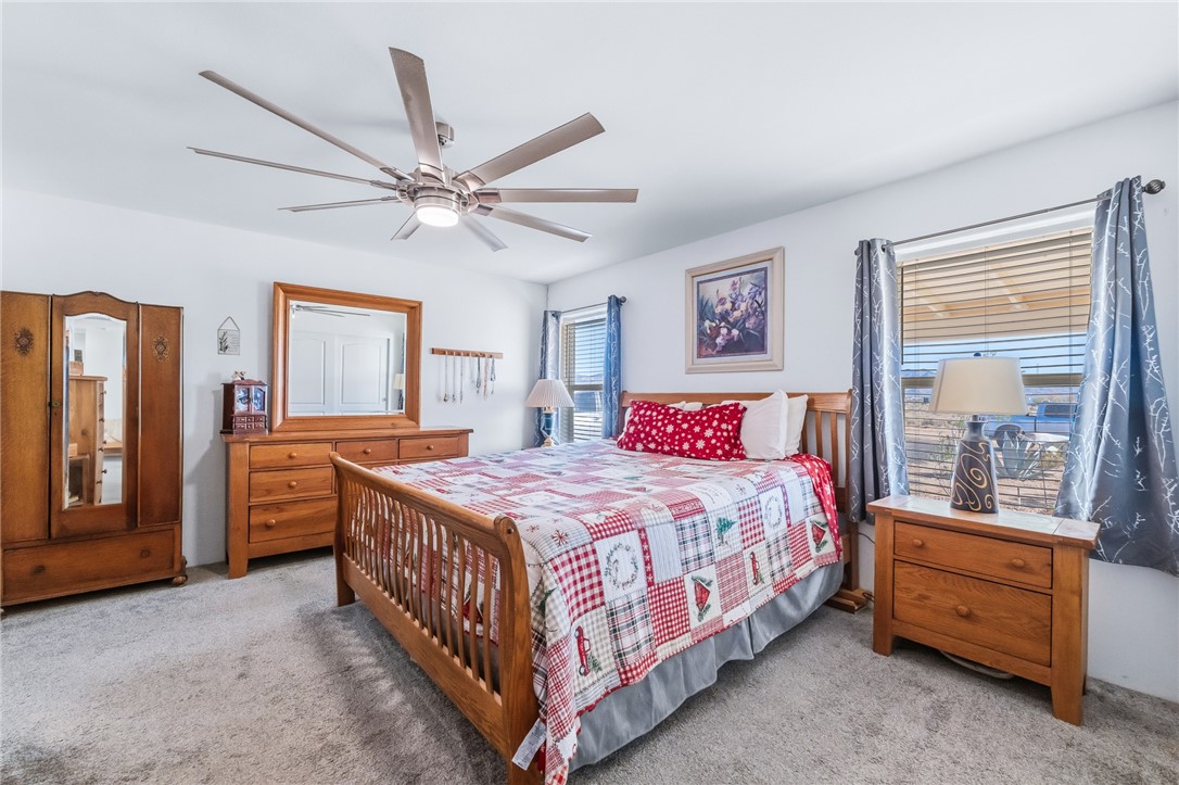 429 South Lochiel Road Golden Valley, AZ 86413 - Photo 23 of 61 Bedroom with light colored carpet and ceiling fan