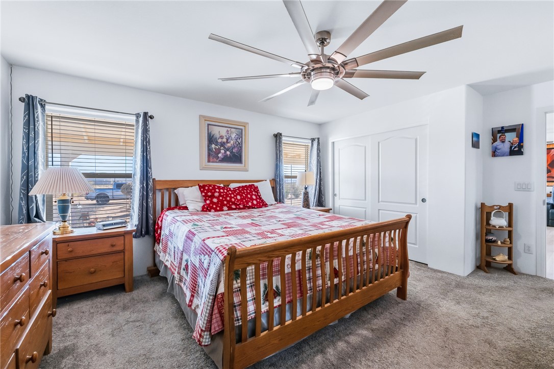 429 South Lochiel Road Golden Valley, AZ 86413 - Photo 25 of 61 Bedroom with a closet, carpet floors, and a ceiling fan