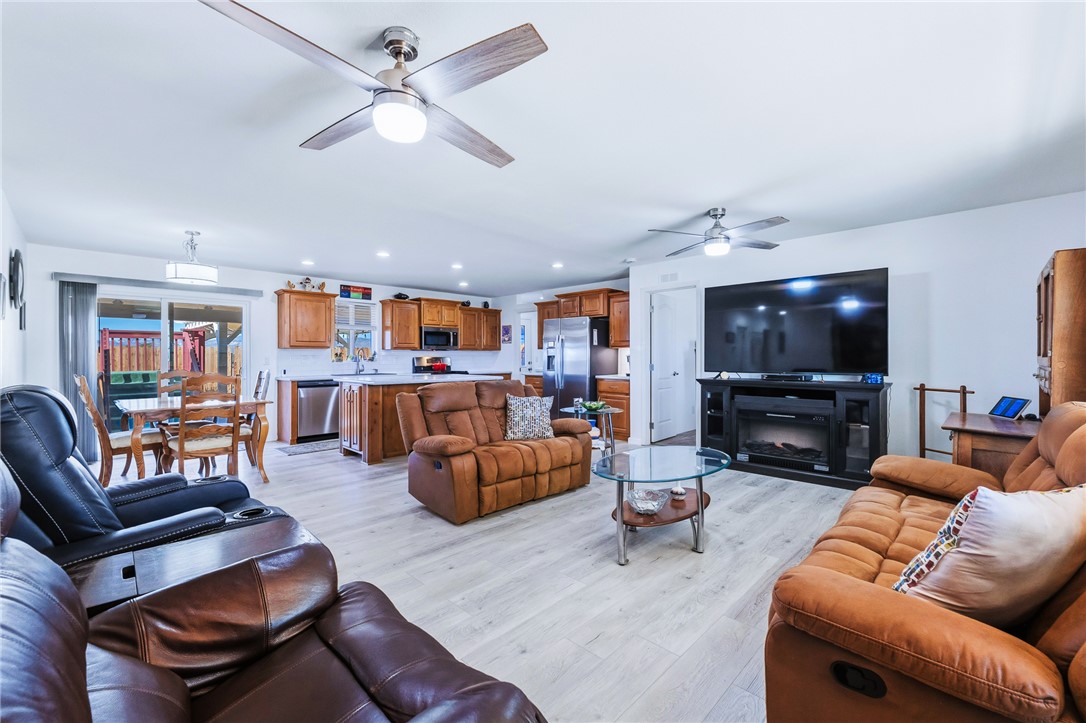 429 South Lochiel Road Golden Valley, AZ 86413 - Photo 3 of 61 Living room featuring a ceiling fan, light wood finished floors, and recessed lighting