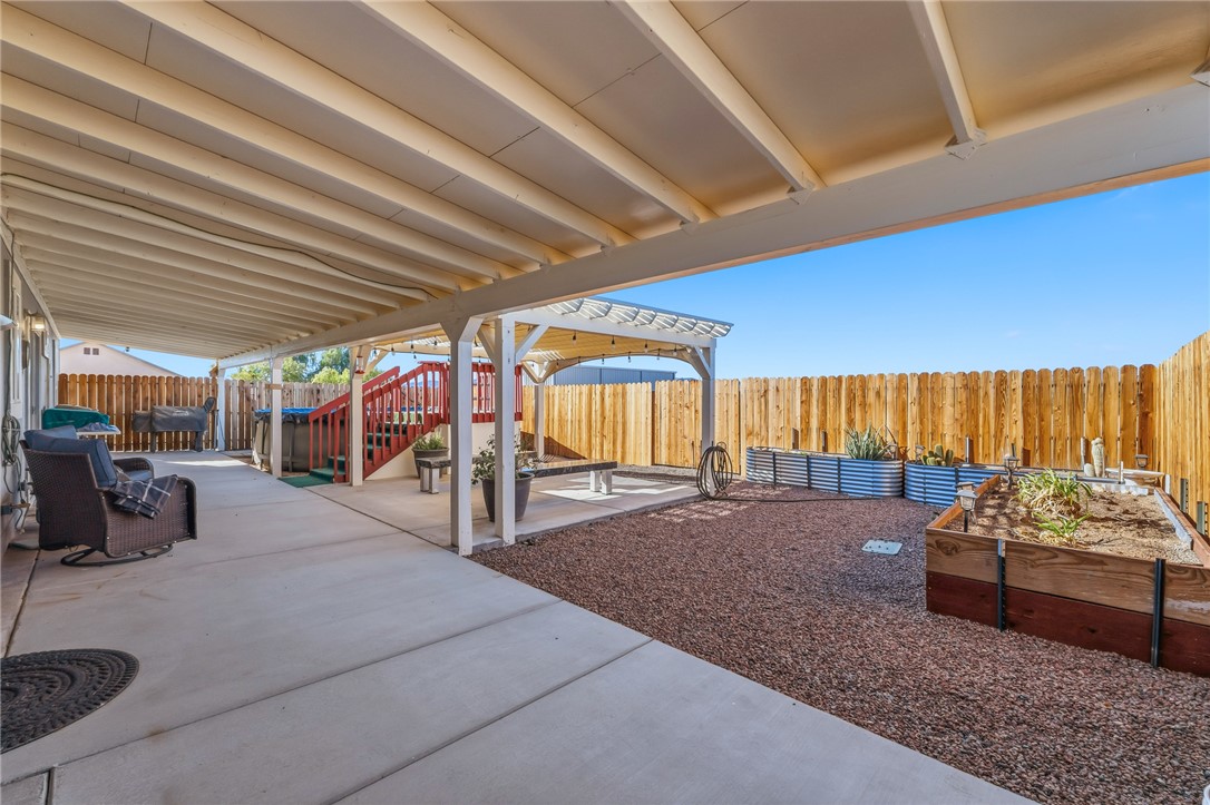 429 South Lochiel Road Golden Valley, AZ 86413 - Photo 36 of 61 Fenced backyard featuring a patio and garden beds