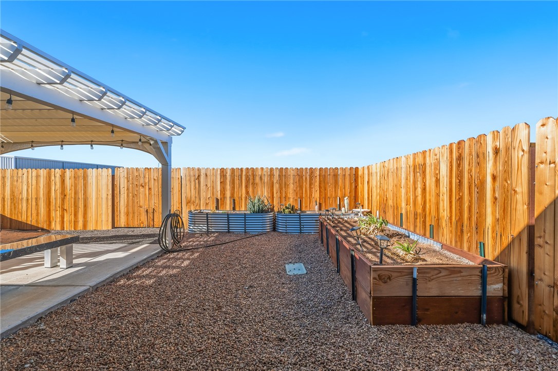 429 South Lochiel Road Golden Valley, AZ 86413 - Photo 38 of 61 Fenced backyard featuring garden beds