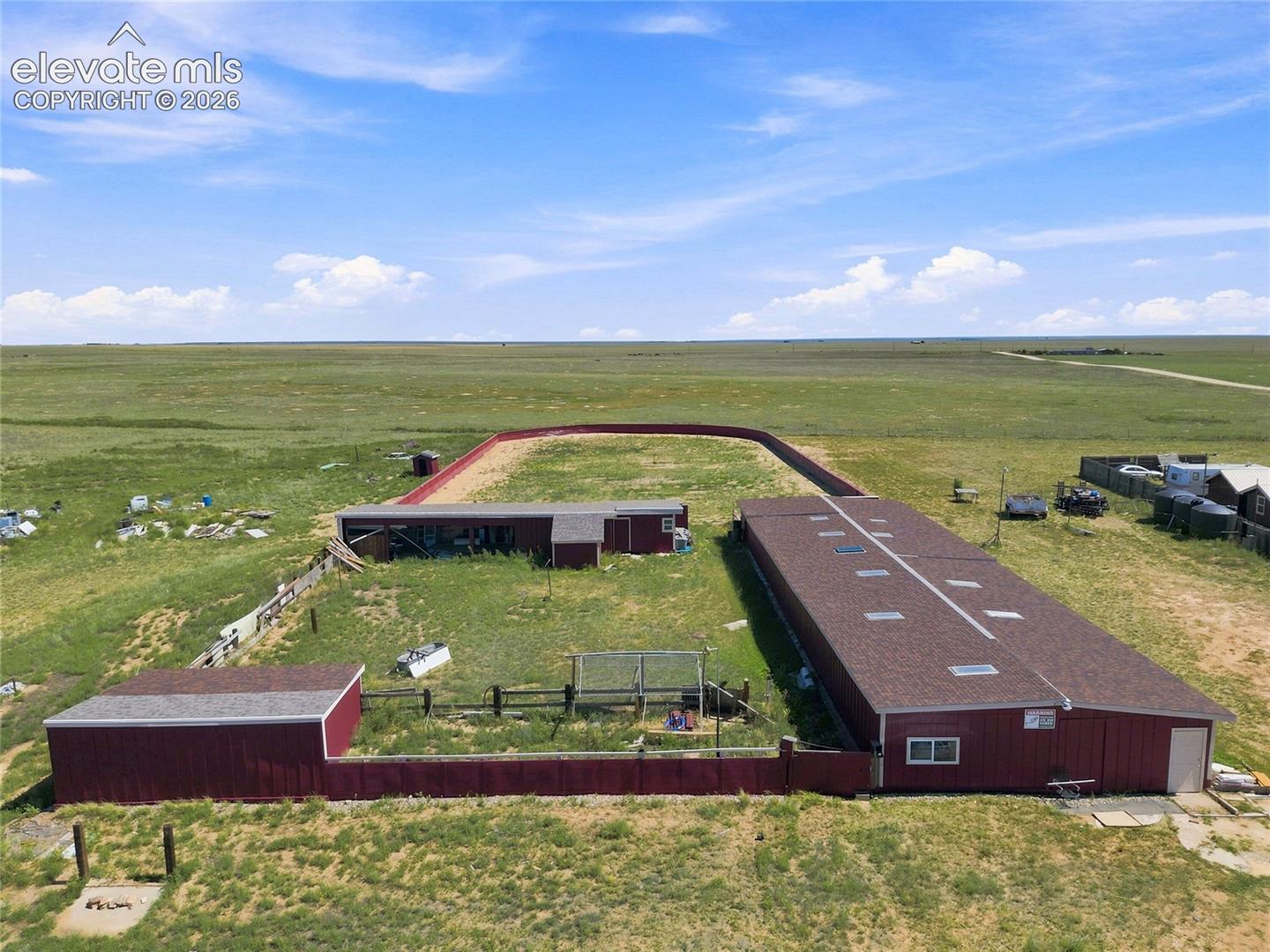 1497 County Road South Rush, CO 80833 - Photo 26 of 29 Large horse stable pictured, horse arena/run pictured, chicken coop pictured, additional sheds/storage areas pictured.