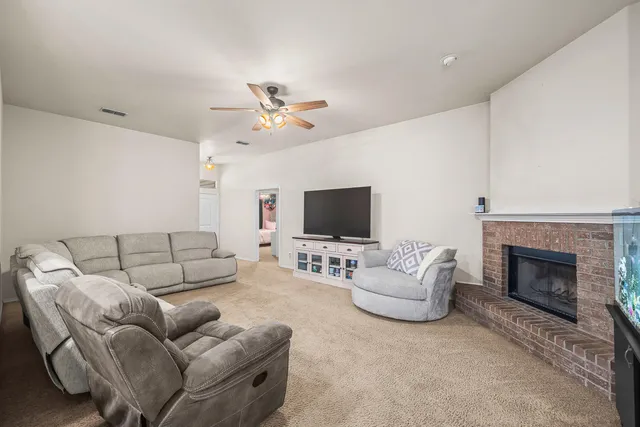 a large kitchen with a table chairs stainless steel appliances and cabinets