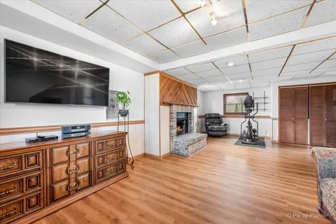 a kitchen with stainless steel appliances kitchen island granite countertop a stove and a wooden floors