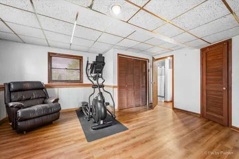 a livingroom with furniture a flat screen tv and a window