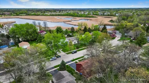 an aerial view of lake residential house with swimming pool and outdoor space
