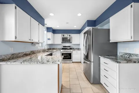 a kitchen with granite countertop cabinets and steel stainless steel appliances