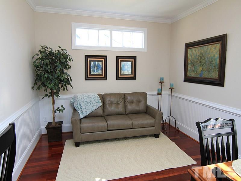 3201 Ringland Road Raleigh, NC 27613 - Photo 11 of 25 a living room with furniture a potted plant and a window