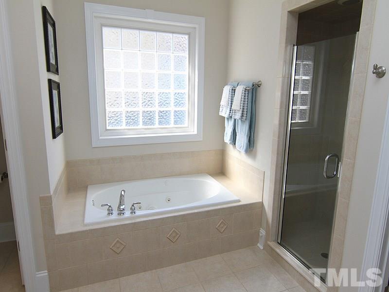 3201 Ringland Road Raleigh, NC 27613 - Photo 13 of 25 a bathroom with a bathtub and a sink