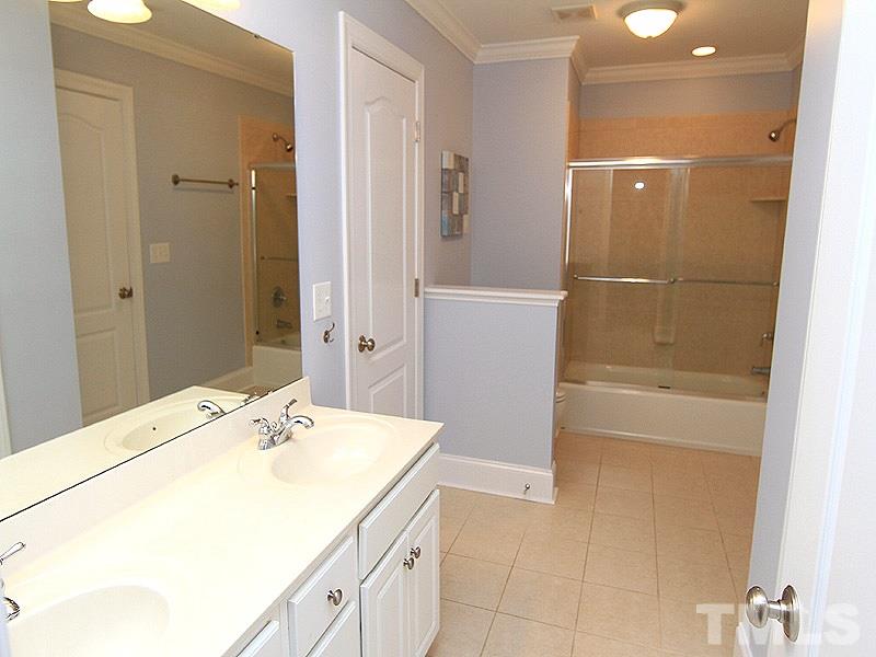3201 Ringland Road Raleigh, NC 27613 - Photo 16 of 25 a bathroom with a sink and a mirror