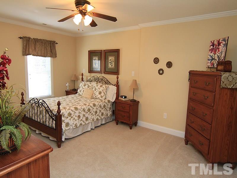 3201 Ringland Road Raleigh, NC 27613 - Photo 22 of 25 a bedroom with a bed and a dresser