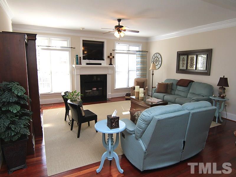 3201 Ringland Road Raleigh, NC 27613 - Photo 5 of 25 a living room with furniture a fireplace and a flat screen tv
