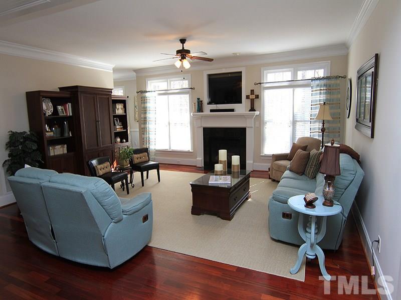 3201 Ringland Road Raleigh, NC 27613 - Photo 6 of 25 a living room with furniture a flat screen tv and a fireplace