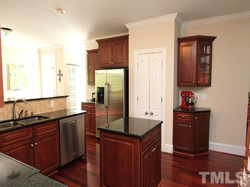 3201 Ringland Road Raleigh, NC 27613 - Photo 7 of 25 a kitchen with stainless steel appliances granite countertop a sink stove and refrigerator