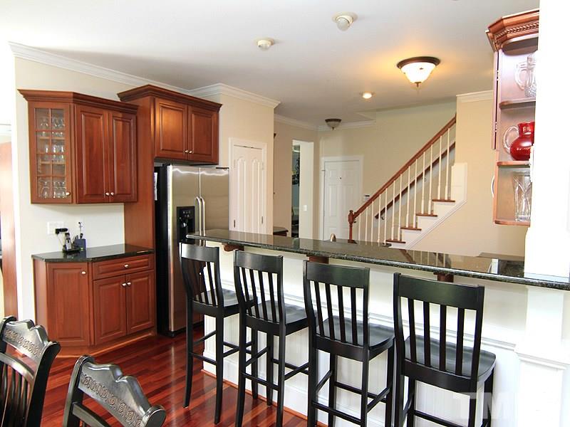 3201 Ringland Road Raleigh, NC 27613 - Photo 9 of 25 a view of a kitchen with furniture and wooden floor