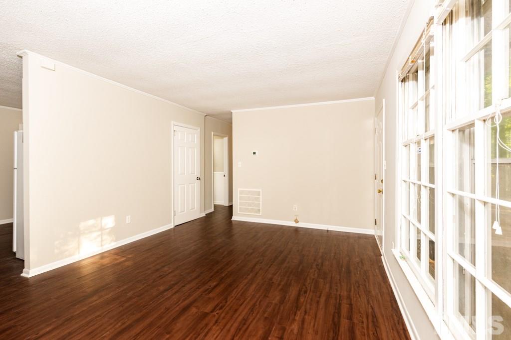 2705 Whitfield Road Chapel Hill, NC 27514 - Photo 3 of 15 a view of an empty room with wooden floor