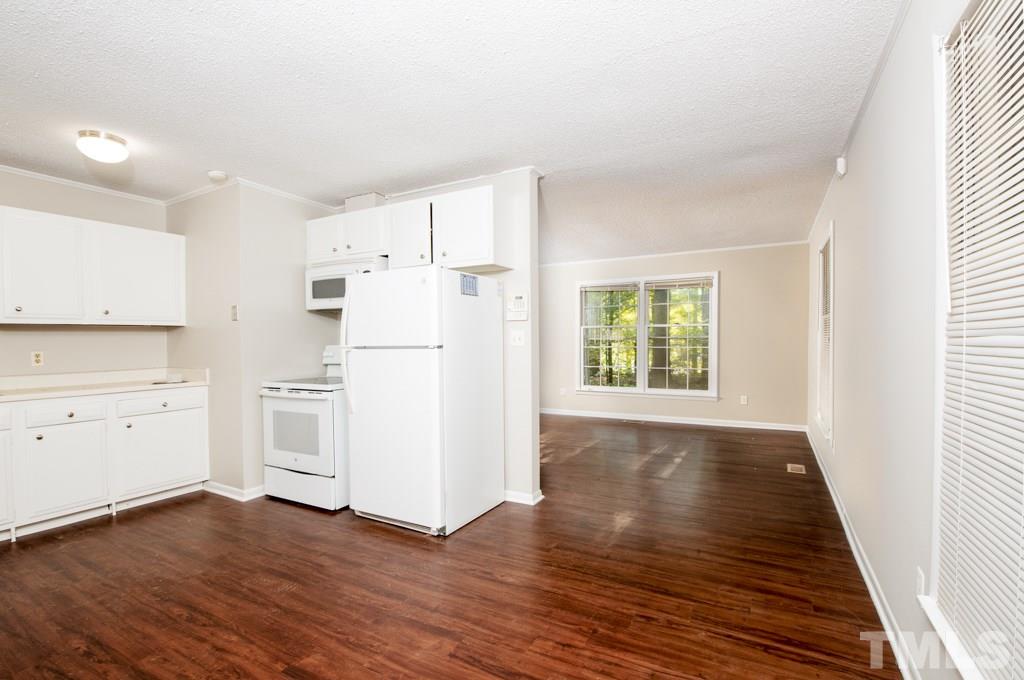 2705 Whitfield Road Chapel Hill, NC 27514 - Photo 4 of 15 a kitchen with wooden floors and white appliances