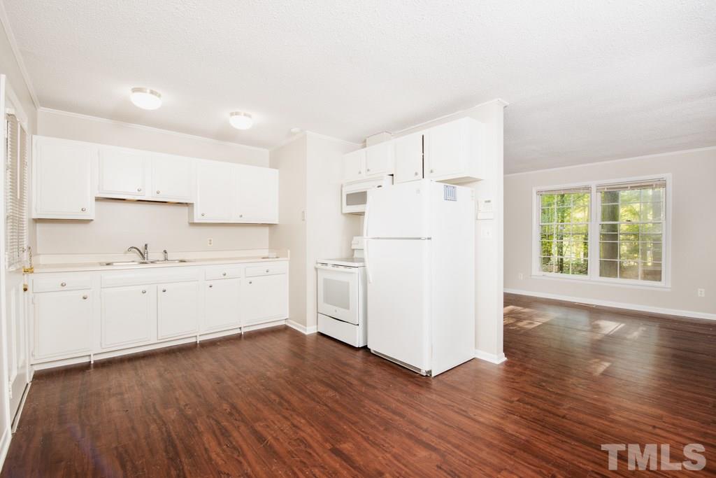 2705 Whitfield Road Chapel Hill, NC 27514 - Photo 5 of 15 a kitchen with wooden floors and white appliances
