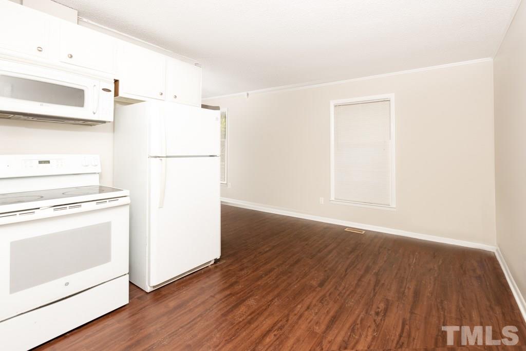 2705 Whitfield Road Chapel Hill, NC 27514 - Photo 6 of 15 a view of a kitchen with refrigerator and wooden floor