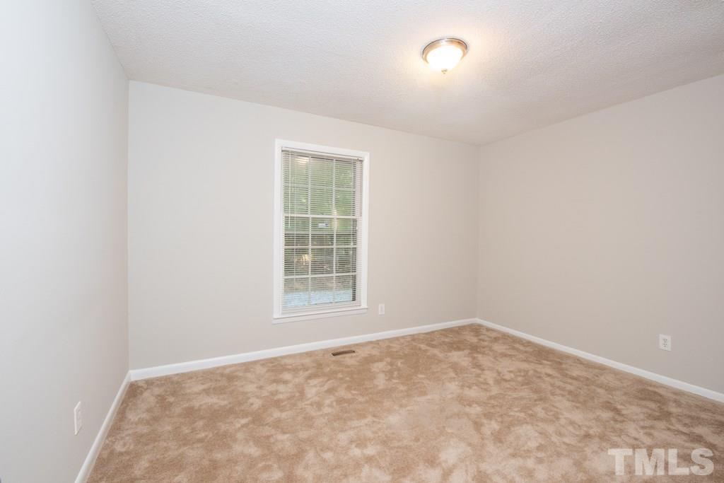 2705 Whitfield Road Chapel Hill, NC 27514 - Photo 8 of 15 an empty room with a window