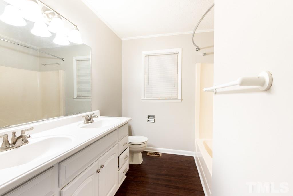 2705 Whitfield Road Chapel Hill, NC 27514 - Photo 9 of 15 a bathroom with a sink a toilet and a mirror