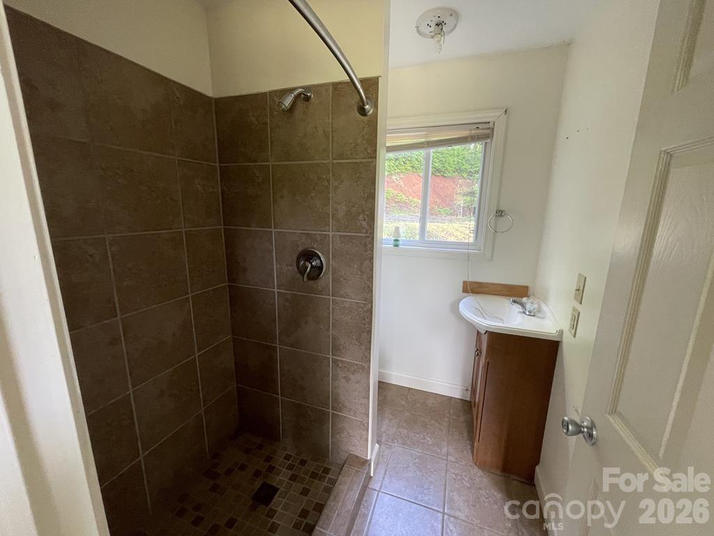 930 Copperhead Cove Road Sylva, NC 28779 - Photo 18 of 18 a bathroom with a shower and toilet