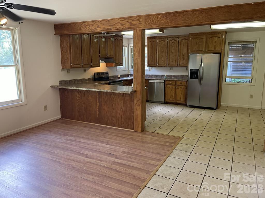 930 Copperhead Cove Road Sylva, NC 28779 - Photo 7 of 18 a kitchen with stainless steel appliances granite countertop a stove a sink and a refrigerator