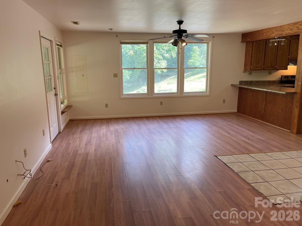 930 Copperhead Cove Road Sylva, NC 28779 - Photo 8 of 18 an empty room with wooden floor and windows