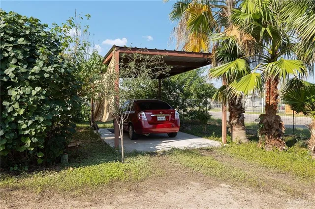 a backyard of a house with barbeque oven table and chairs