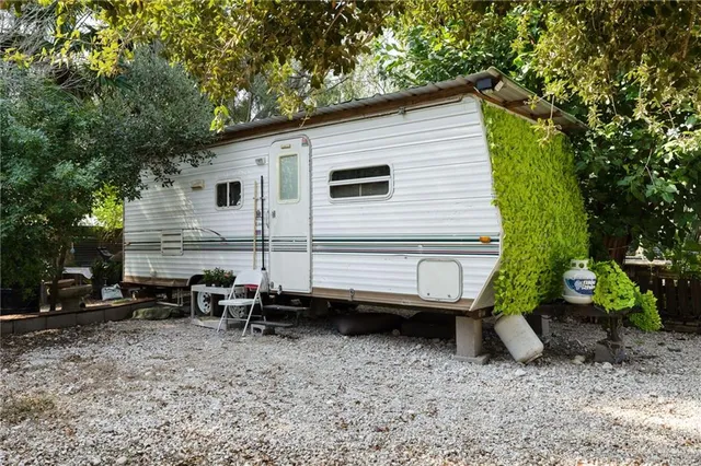 a view of a back yard of the house and a car parked