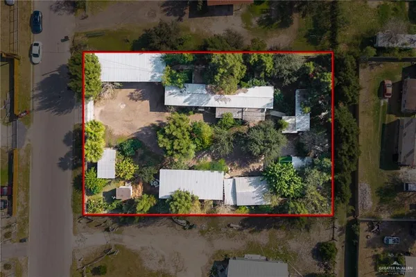 an aerial view of a house with a yard